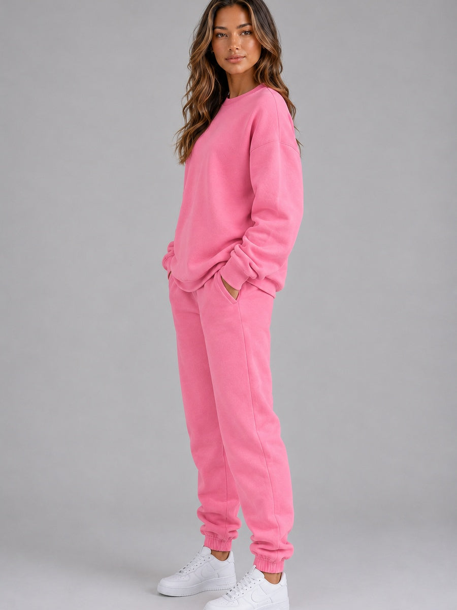 Roze joggingpak, zijkant met een hand in de zak