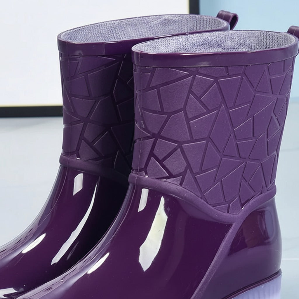 Glanzende halfhoge regenlaarzen met geometrisch patroon in paars, close-up