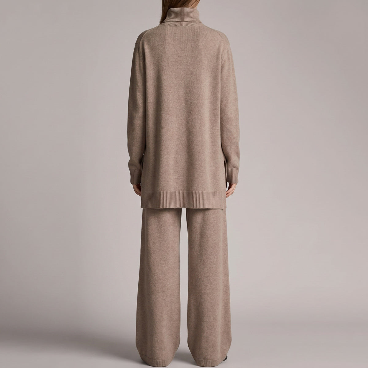 Beige gebreide coltrui met wijde broek, gedragen door vrouw op rug | Boutique Moda
