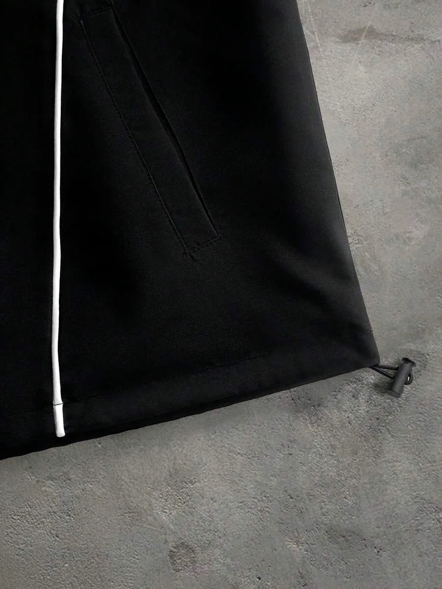 Korte herenjas met capuchon in zwart, close-up van de zoom met trekkoord