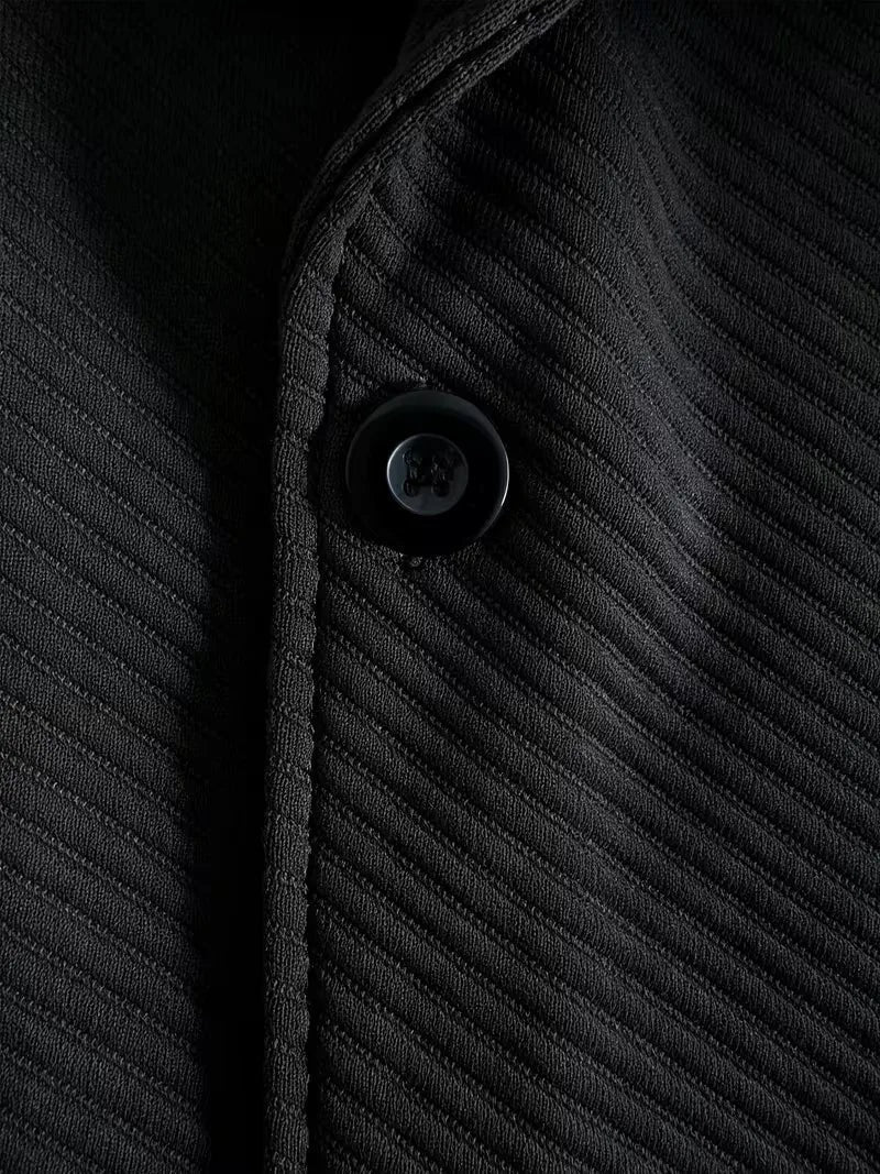 Heren blazer met gebreide structuur in zwart, close-up van de knoop