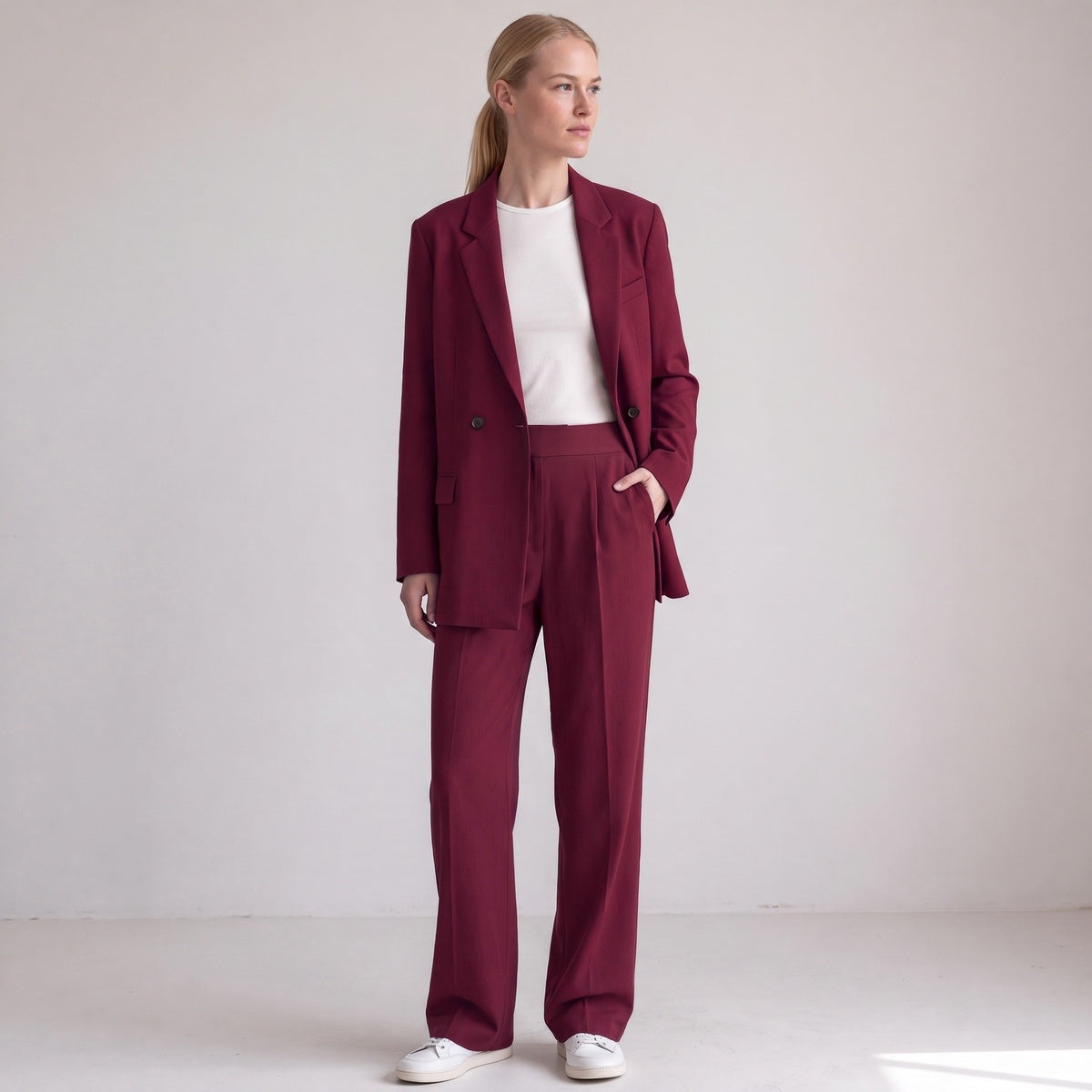 Broekpak met double-breasted blazer en wijde broek in bordeaux, volledige look aan het model
