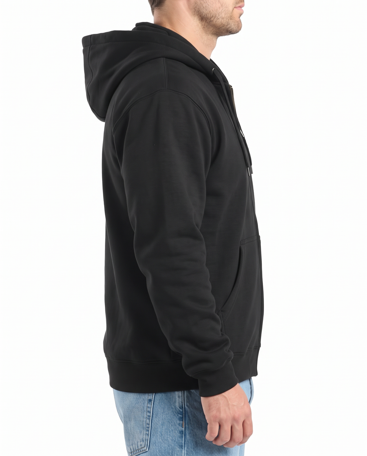 A man seen from behind wearing a black zip-up hoodie with the hood up, paired with blue jeans, side view