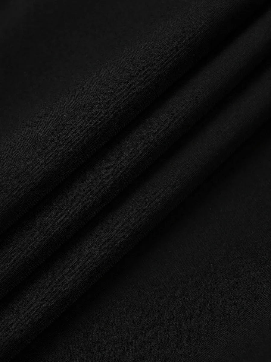 Close-up macro shot of folded black fabric, likely a garment detail.