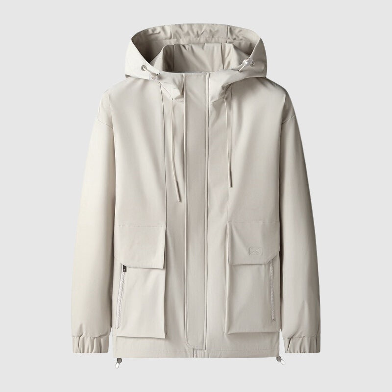 Beige windjack met capuchon en zakken, plat gefotografeerd | Boutique Moda