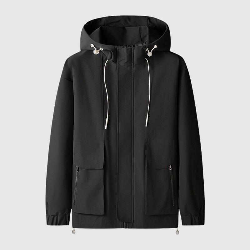 Zwart windjack met capuchon en trekkoorden, los op lichte achtergrond | Boutique Moda