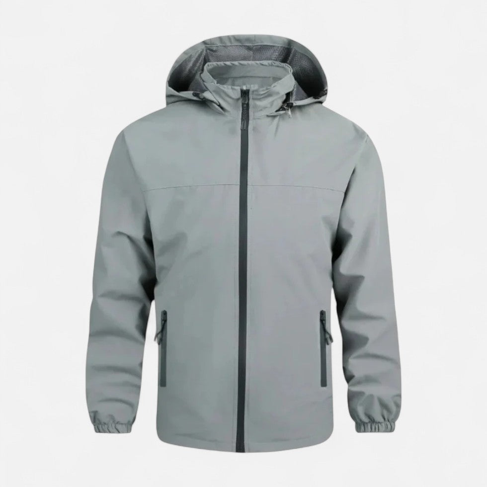 Grijze windbreaker met capuchon en ritszakken, plat liggend gefotografeerd | Boutique Moda