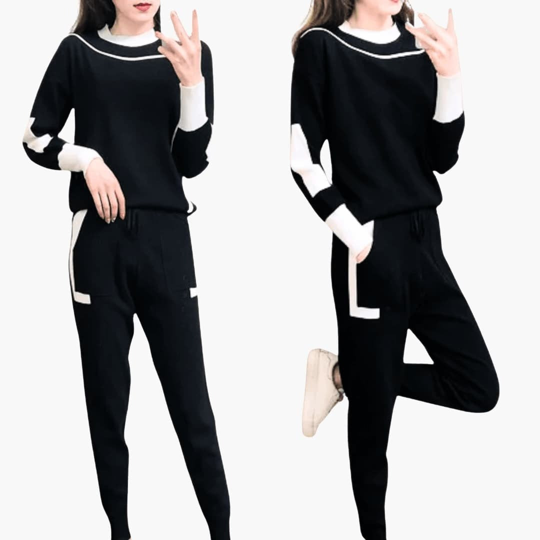 Vrouw in het zwarte gebreide joggingpak met witte contrastdetails