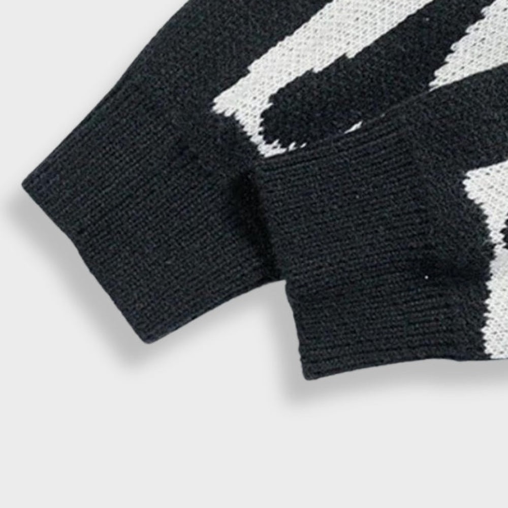 Close-up van zwart-witte gebreide mouw met manchet, geen persoon zichtbaar | Boutique Moda