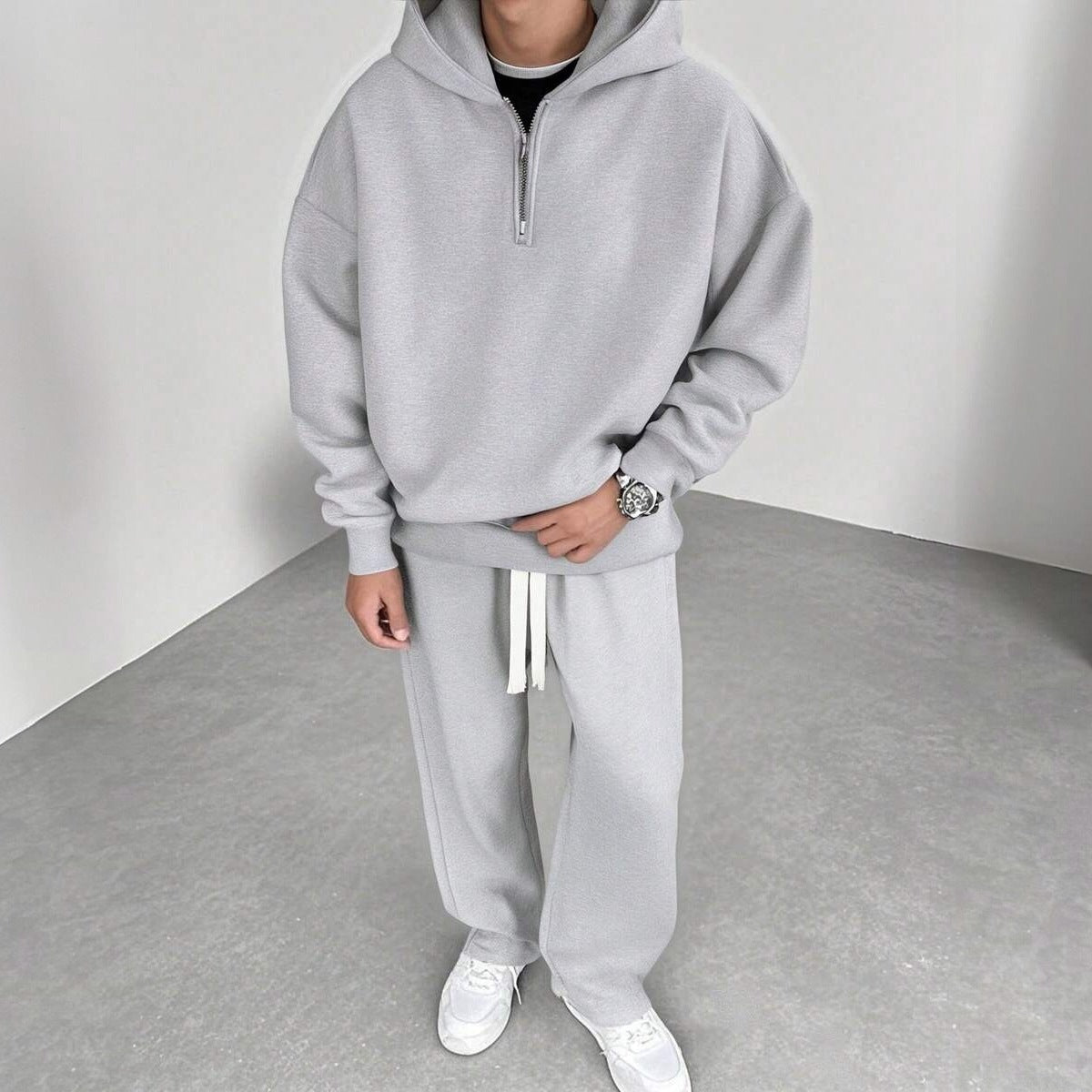 Grijze joggingpak met halfzip hoodie en wijde broek, gedragen door man | Boutique Moda