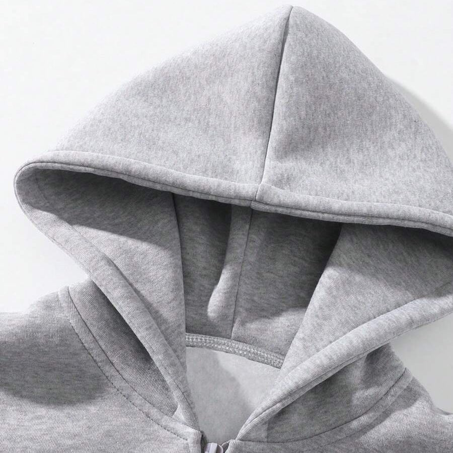 Close-up van grijze hoodie met capuchon en rits, geen persoon zichtbaar | Boutique Moda