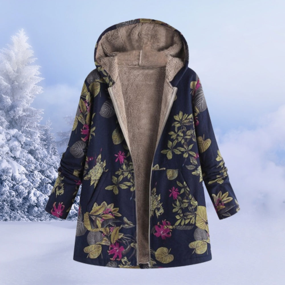 Omkeerbare winterjas met capuchon in donkerblauw met bloemen, aan een hanger, open, met zicht op de fleecevoering
