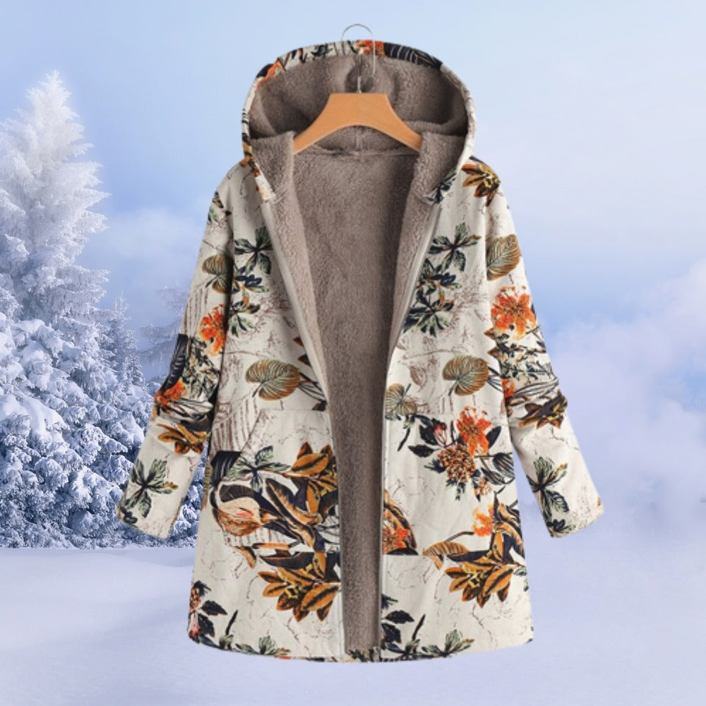 Omkeerbare winterjas met capuchon in crème met oranje bloemen, aan een hanger, open, met zicht op de fleecevoering