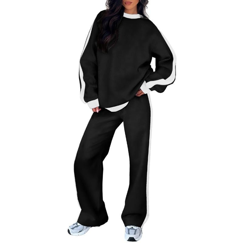 Joggingpak met zijstreep, sweater en rechte broek in zwart, gedragen, vooraanzicht