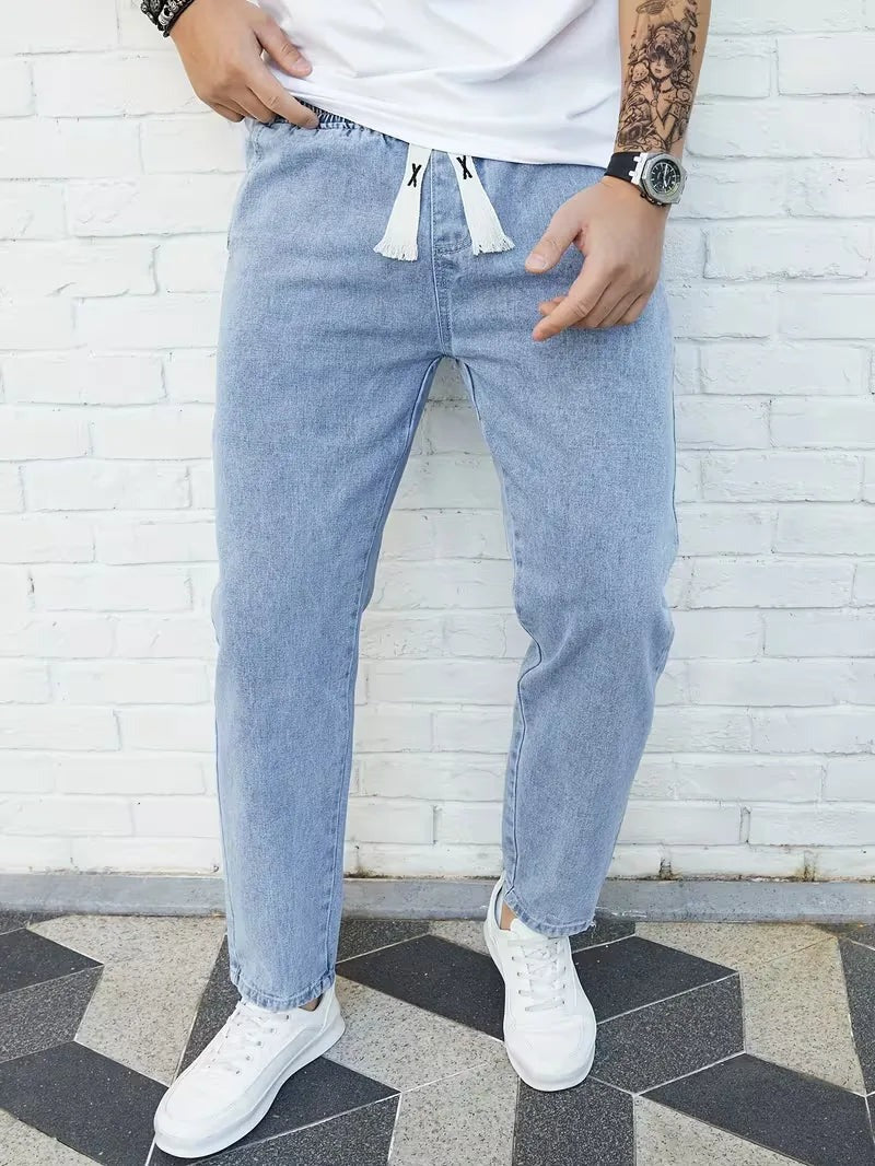 Joggerjeans voor heren in lichtblauw met trekkoord, gedragen, voorkant