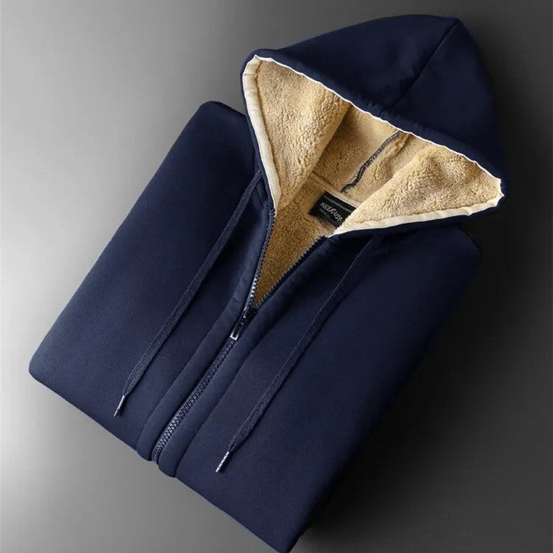 Marineblauw vest opgevouwen, met zicht op de teddyvoering in de capuchon en het lijf | Boutique Moda