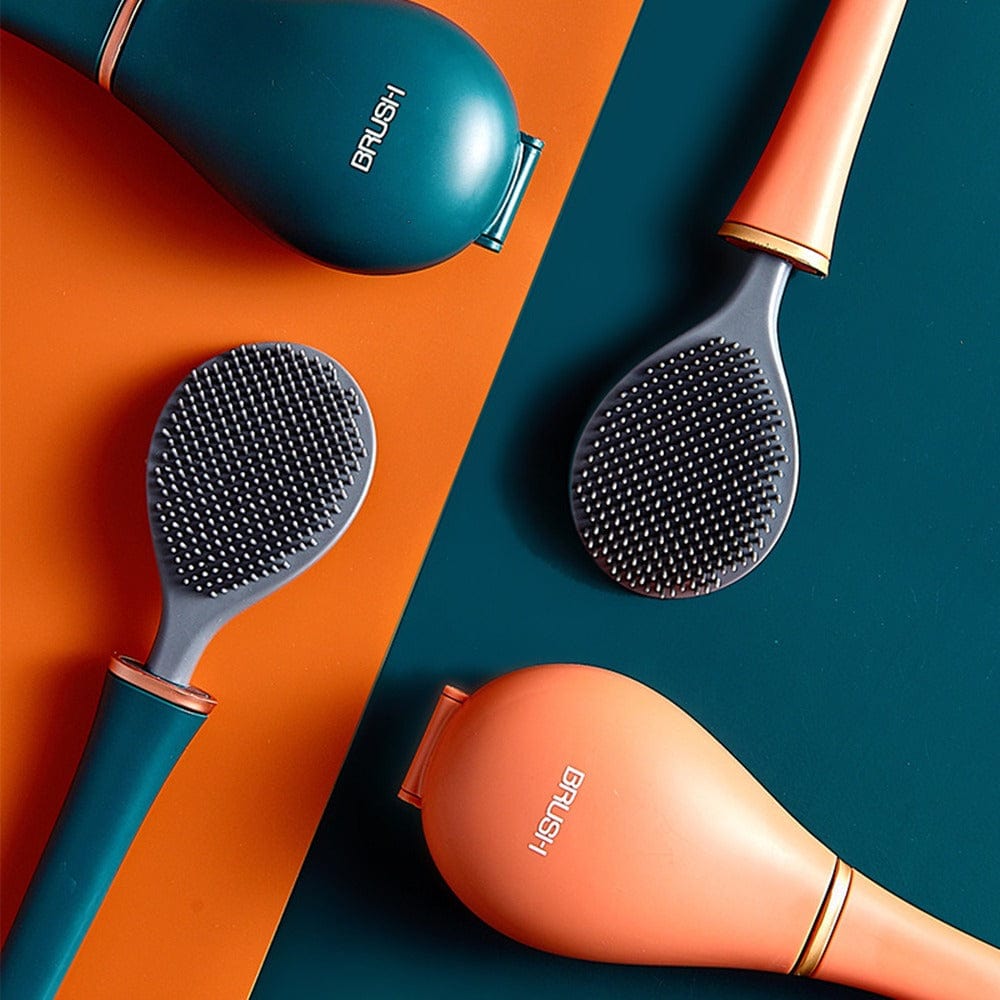 Twee groene en twee oranje haarborstels met houder, plat uitgestald | Boutique Moda