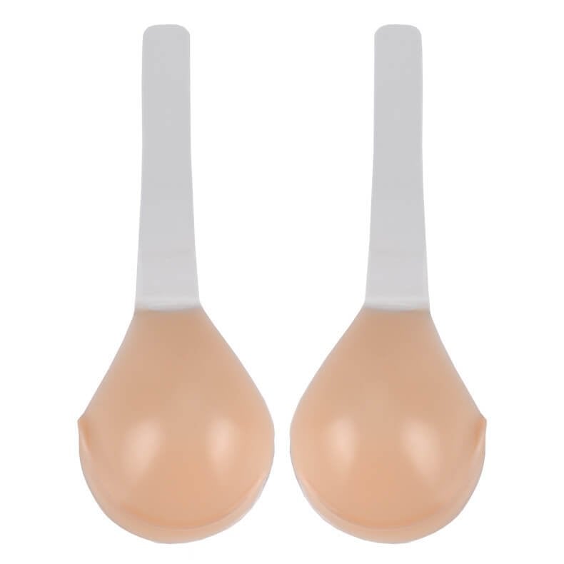 Twee huidkleurige siliconen plak-bh cups met witte lepelvormige handgrepen, plat liggend | Boutique Moda