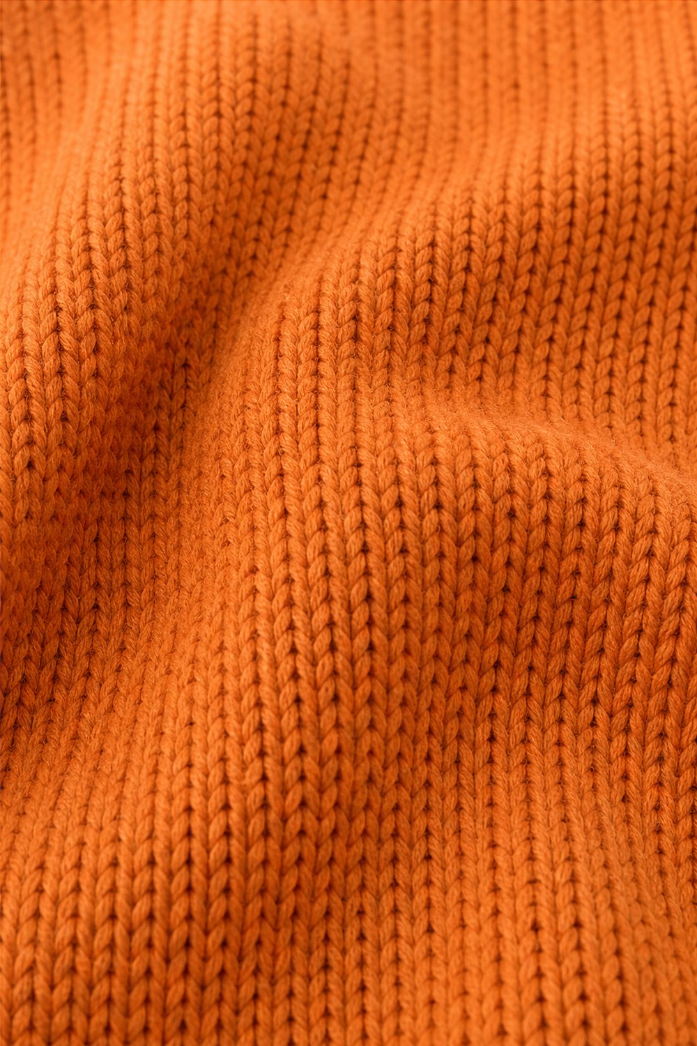 Close-up van het fijne oranje breisel | Boutique Moda