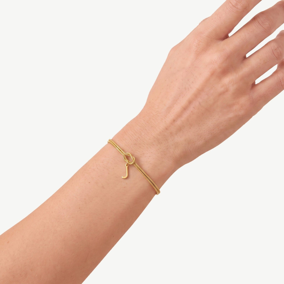 Gouden initiaal armband met letter J om de pols