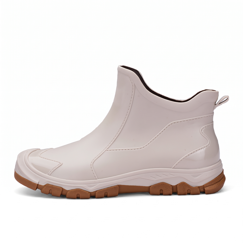 A single off-white rubber ankle boot with a tan tread sole, shown from the side against a white background.