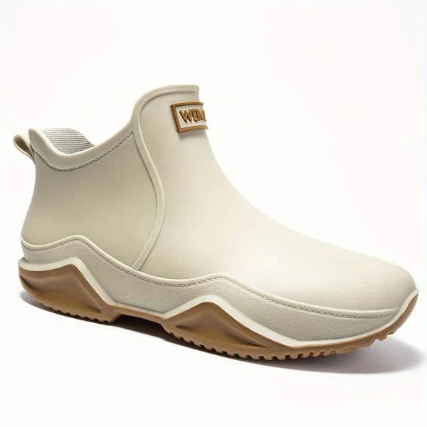 A single beige ankle-height rain boot with a chunky tan sole, shown in three quarter view on a white background, with a small patch on the front of the shaft that appears to read WEI (likely the weikani supplier label).