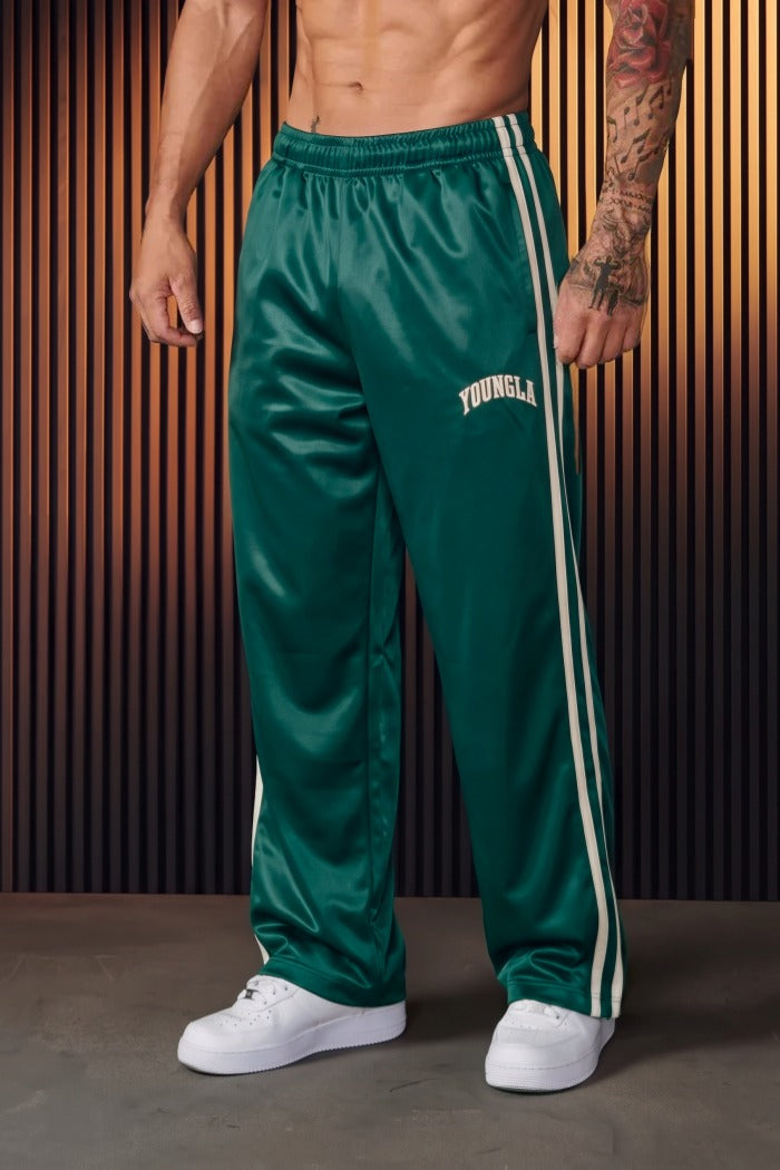Groene joggingbroek met witte strepen gedragen door man, sneakers zichtbaar | Boutique Moda