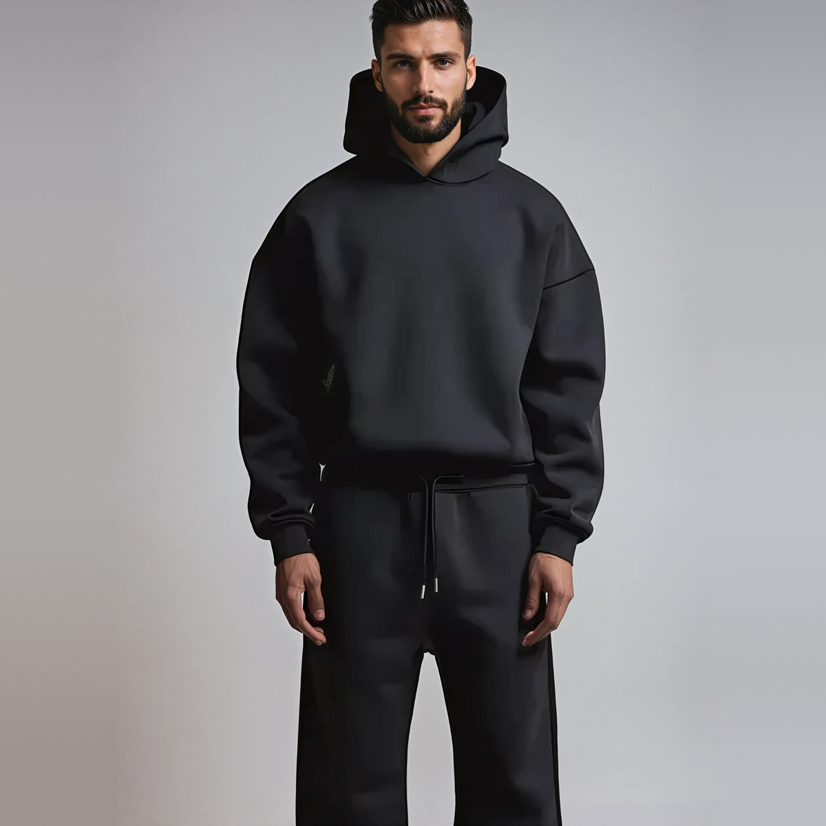 Man draagt zwarte hoodie en joggingbroek set, volledig gekleed | Boutique Moda