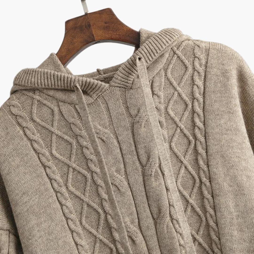 Close-up van het kabelpatroon op de gebreide hoodie in taupe