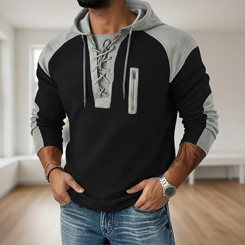 Zwart-grijze hoodie met veterhals, raglanmouwen en ritszak, gedragen door man | Boutique Moda