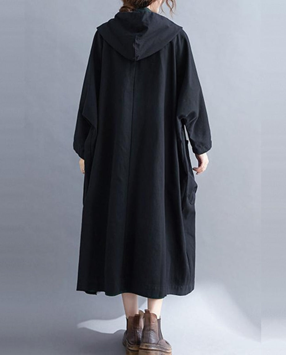 Zwarte oversized regenjas met capuchon, lange mouwen, gedragen door persoon achteraanzicht | Boutique Moda