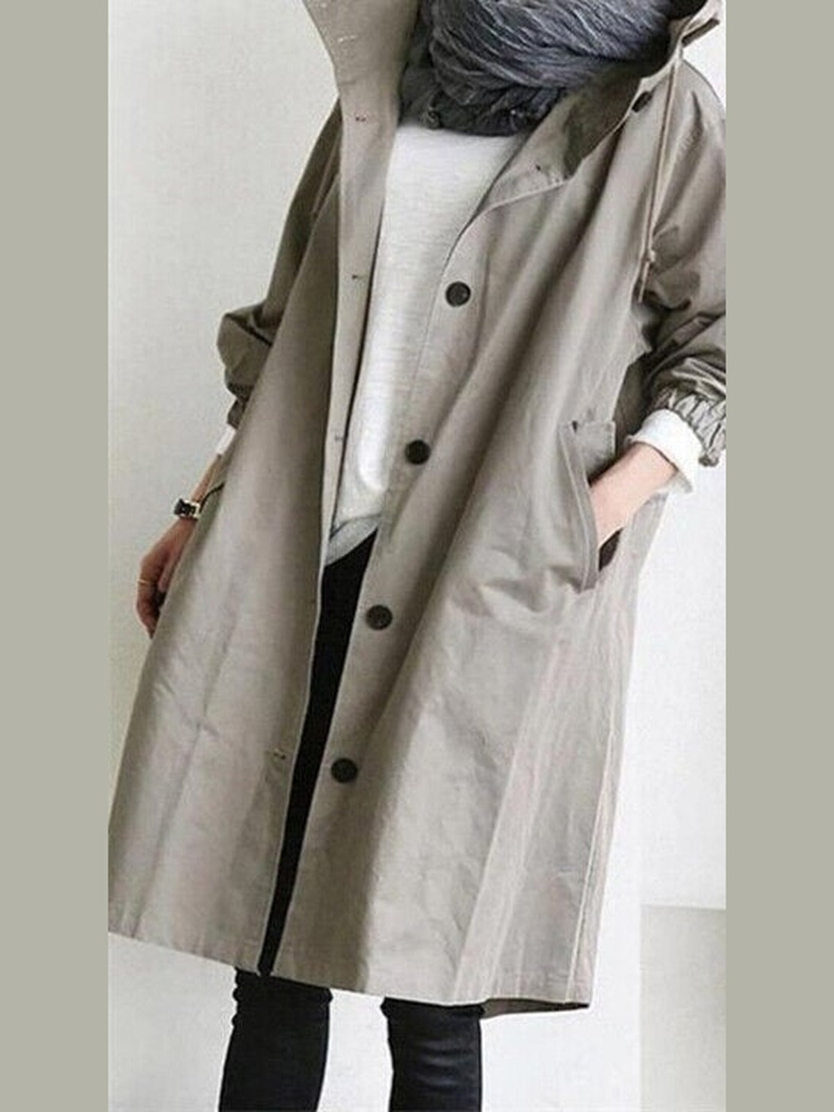 Trenchcoat met capuchon in steengrijs, open gedragen over een wit shirt | Boutique Moda