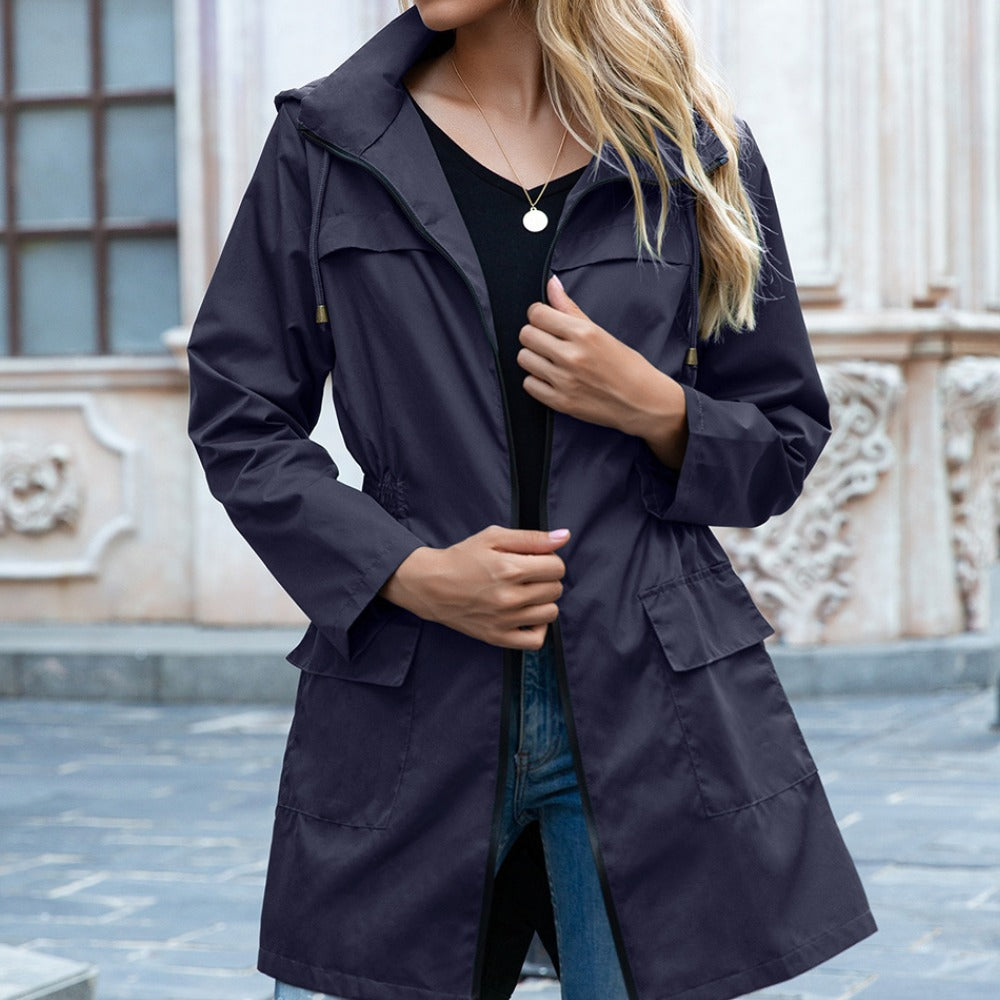 Marineblauwe lange waterdichte regenjas met capuchon en klepzakken, open gedragen | Boutique Moda
