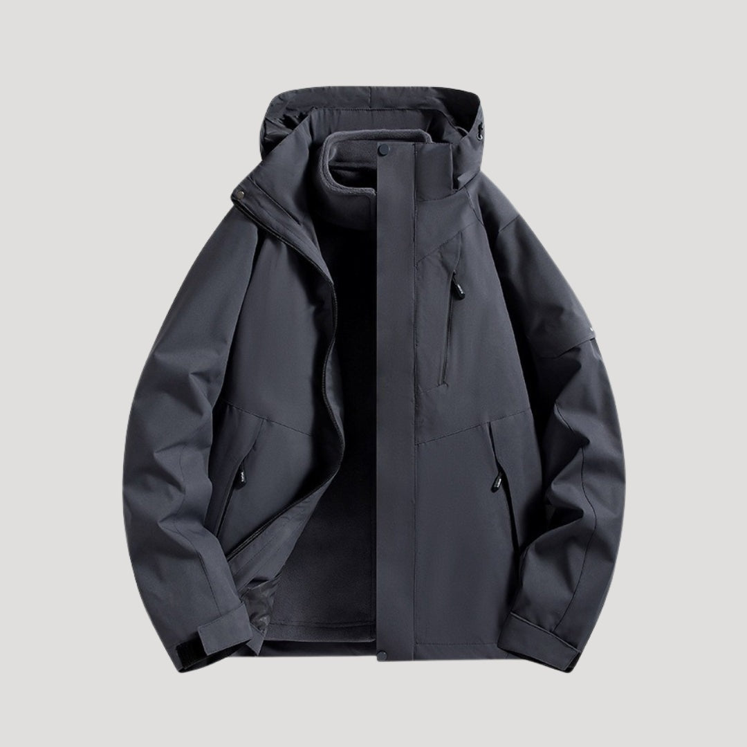 Outdoorjas in zwart, waterdicht, met capuchon, tweekleurige panelen en ritszakken | Boutique Moda