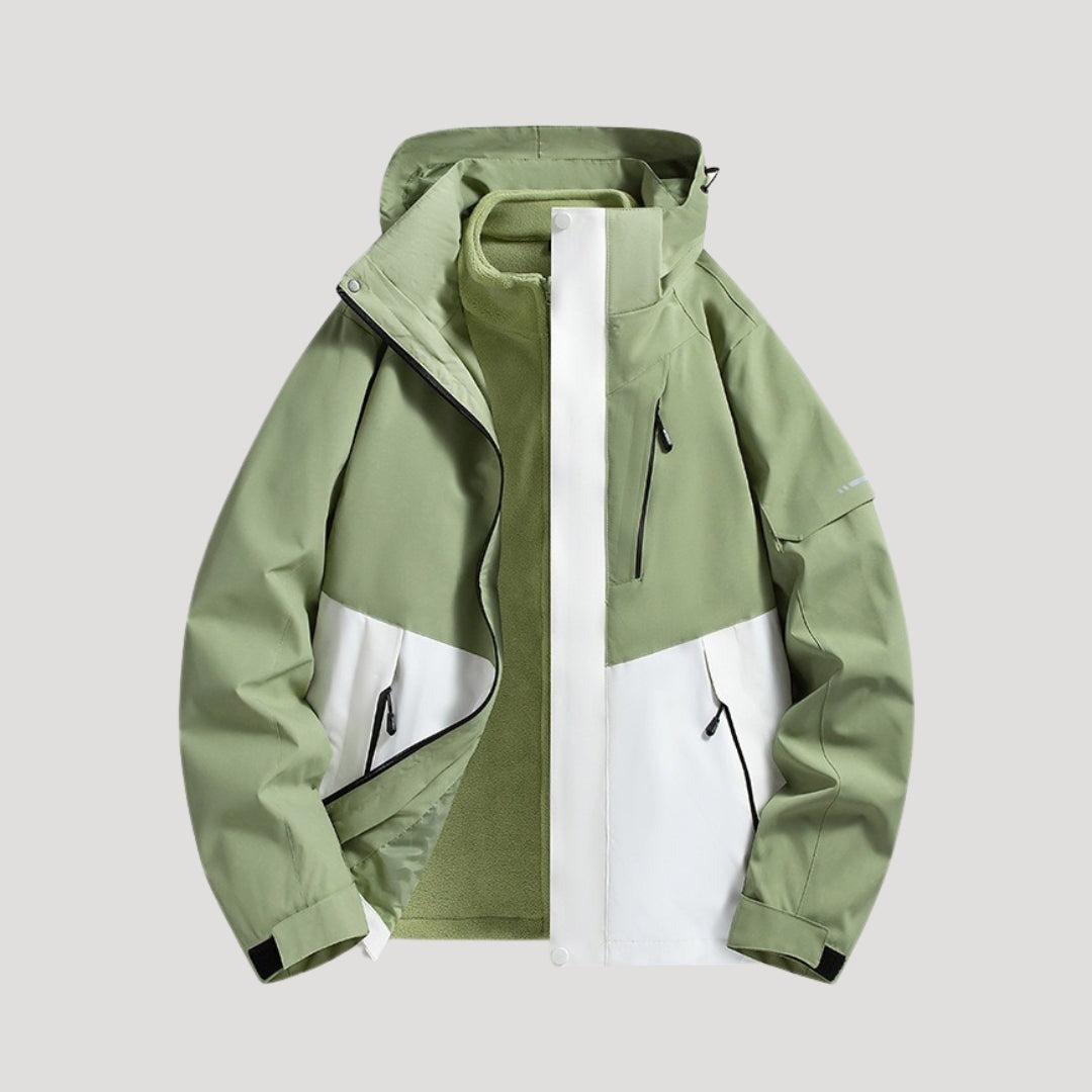 Outdoorjas in lichtgroen, waterdicht, met capuchon, tweekleurige panelen en ritszakken | Boutique Moda