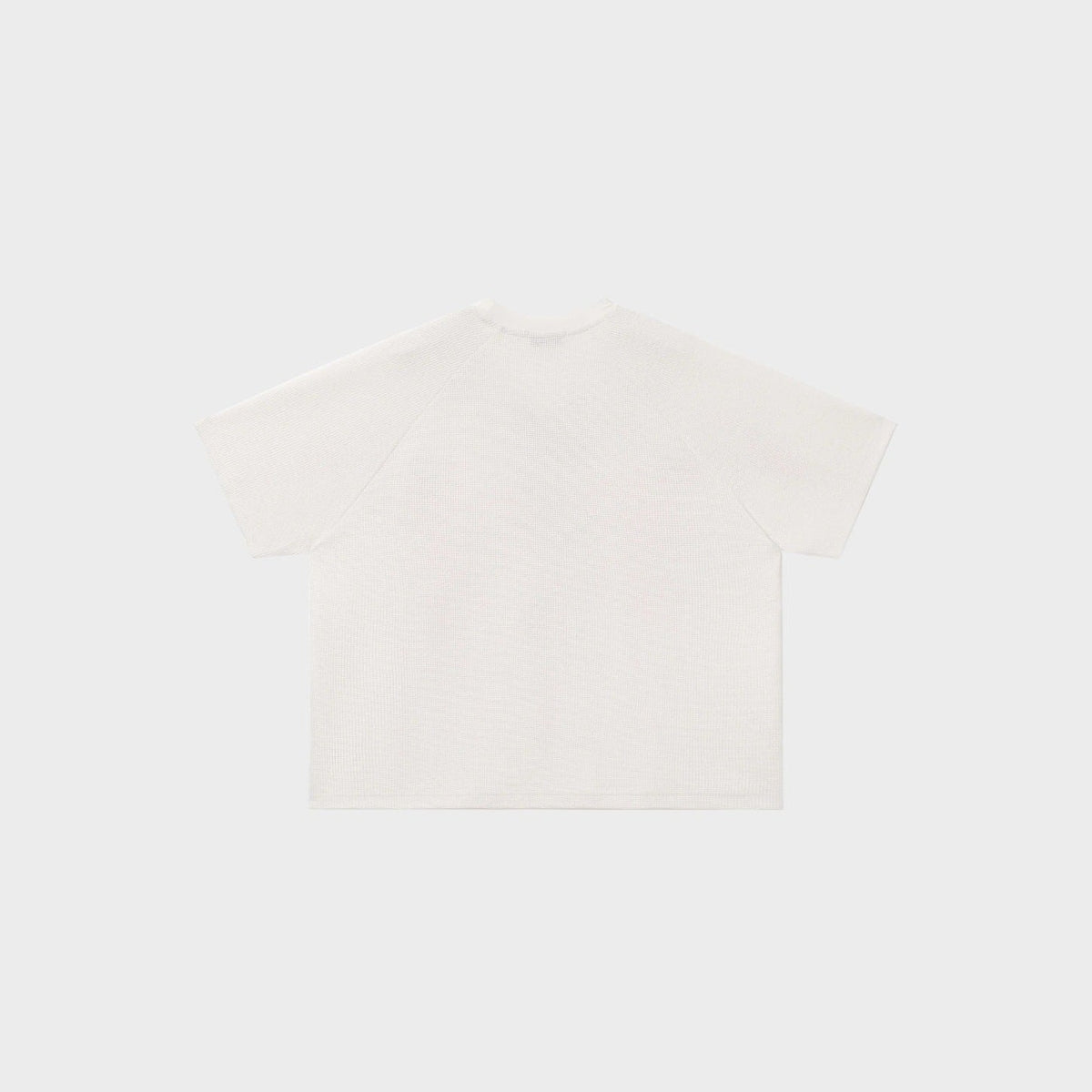 Wit oversized T-shirt met wafelstructuur, plat gefotografeerd, achteraanzicht getoond | Boutique Moda