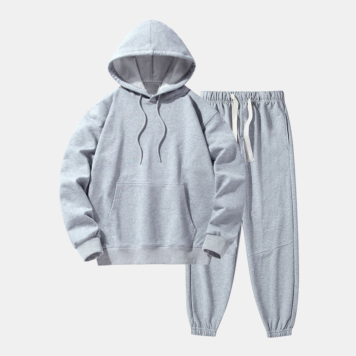 Grijze hoodie met joggingbroek, effen kleur, plat gefotografeerd op lichte achtergrond | Boutique Moda