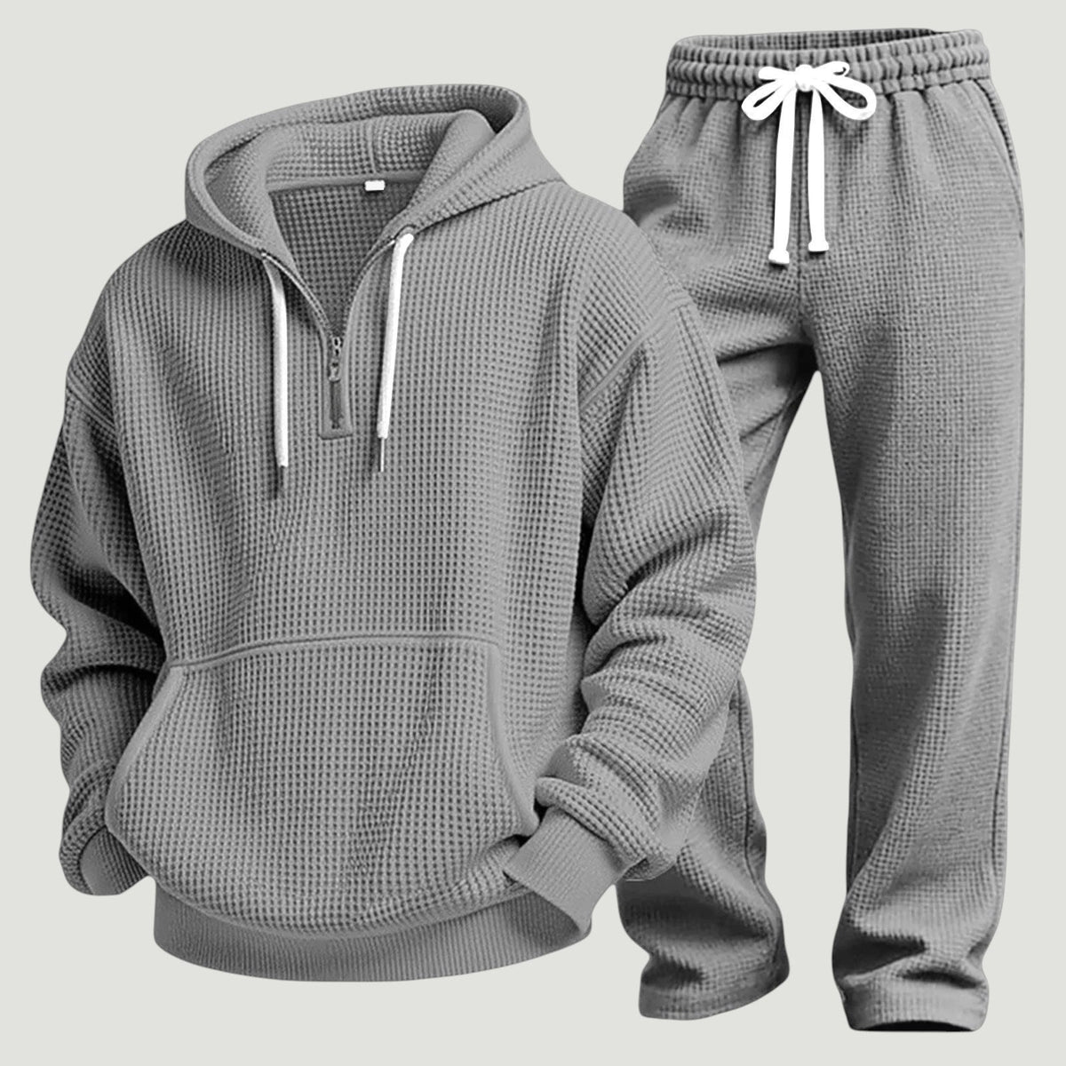 Grijs wafel trainingspak met capuchon en halve rits, platliggend getoond | Boutique Moda