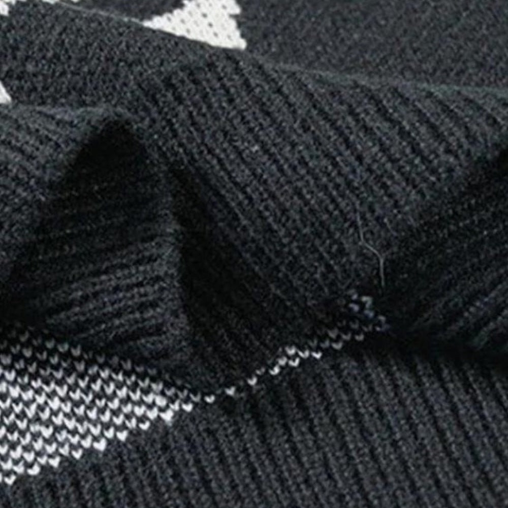 Zwart gebreide stof met jacquard patroon, close-up van geribbelde textuur plat | Boutique Moda