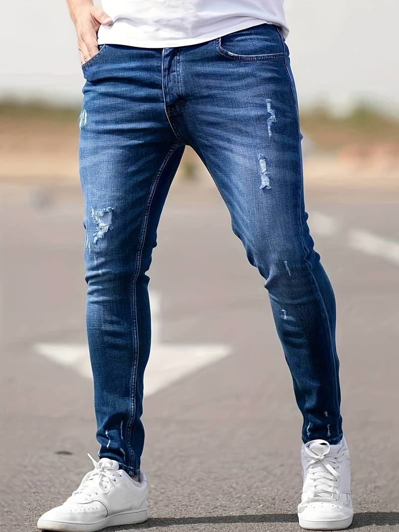 Indigoblauwe skinny spijkerbroek met scheuren gedragen