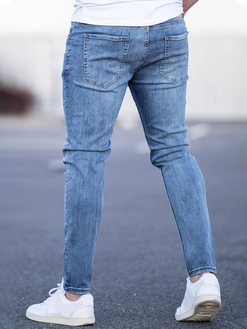 Lichtblauwe skinny spijkerbroek met scheuren gedragen