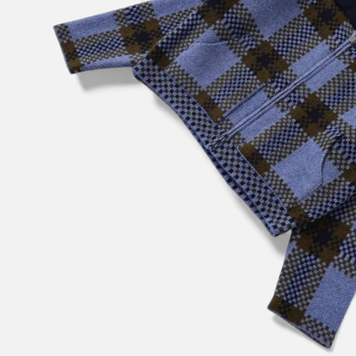 Detail van de mouw en de steekzak van het geruite vest